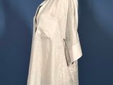 a white shirt on a mannequin stand against a blue wall
