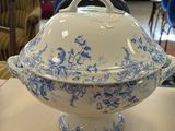 a blue and white bowl with a lid sitting on a table