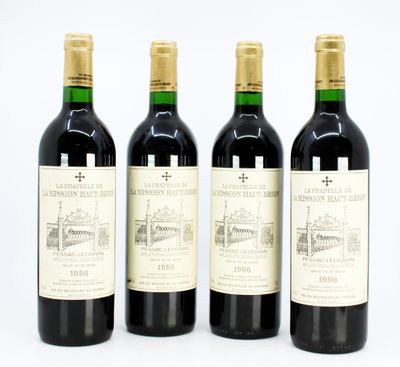 three bottles of red wine are lined up on a white surface