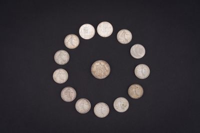 a close up of a circle of coins on a black surface