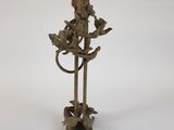 statue of a woman holding a bird on a branch
