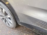 a close up of a car ' s tire on the road