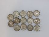 several quarters of coins are arranged in a row on a white surface