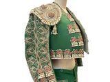 a close up of a green and gold jacket on a mannequin