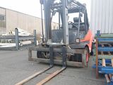 a fork lift truck parked next to a pallet