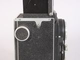 a black and white photo of an old camera
