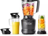 a blender that is sitting next to a blender filled with fruit and vegetables