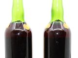 two bottles of wine sitting next to each other on a table