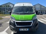 a green and white van parked in front of a building