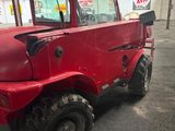 a red truck that is parked in a garage