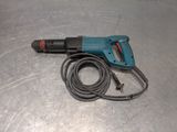 a cord and a drill on a metal surface