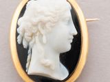 an image of a woman ' s profile in a black and white cameo broochle
