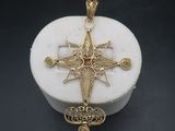 a white marble box with a gold cross on it