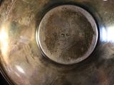 a large metal bowl with a hole in the middle of it