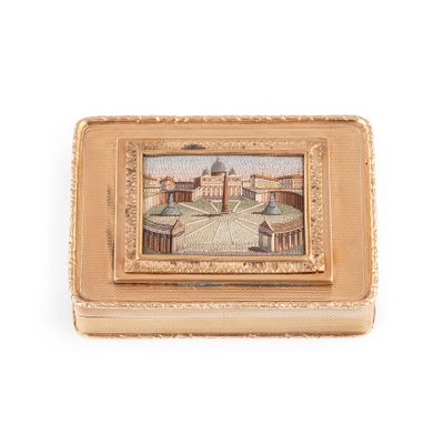 an old gold box with a picture of a building on it
