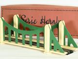 a small model of a bridge with a box in the background