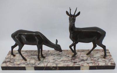 paire de statues en marbre noir et blanc représentant un cerf et une antilope, posées sur un socle en marbre