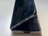 a silver cell phone sitting on top of a white table