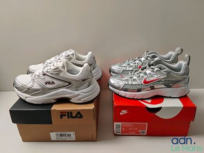 two pairs of shoes are sitting on top of a box