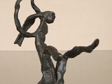 bronze sculpture of a woman with a bird on her shoulder