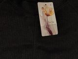 the back of a black sweater with a tag on it