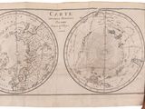 an old map of the world being held up by a hand