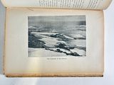 an open book with a picture of a landscape on it