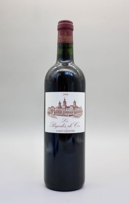 une bouteille de vin rouge posée sur une table blanche