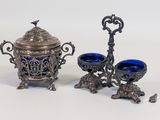 three pieces of silver and blue glass on a white surface