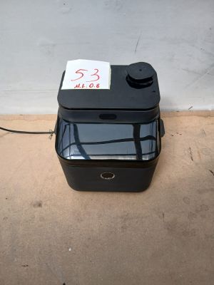 une boîte noire sur laquelle est collé un autocollant, posée par terre