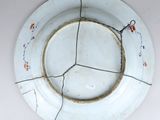 a white plate with a crack in the middle of it