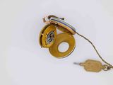 a gold pocket watch and a keychain on a white surface