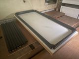 an image of a kitchen with a skylight in the middle of the room