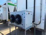 two air conditioning units on the side of a building