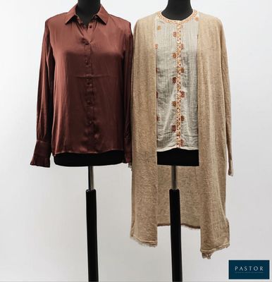 two mannequins are standing next to each other in front of a white wall