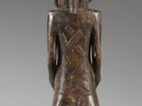 an image of a wooden statue of a man with a hat on his head