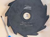 a circular saw blade on a table with a blue tool