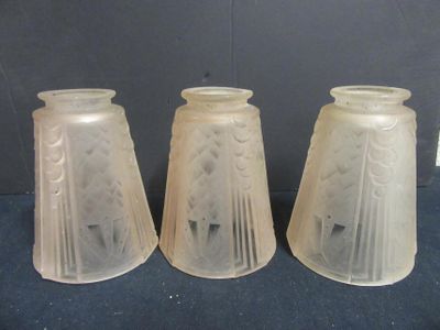 three frosted glass vases are sitting on a blue surface