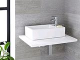 a white sink sitting on a shelf in a bathroom
