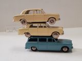 three toy cars stacked on top of each other on a table