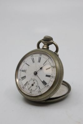 a small pocket watch with roman numerals on it