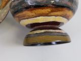 pair of wooden bowls sitting on top of each other on a white surface