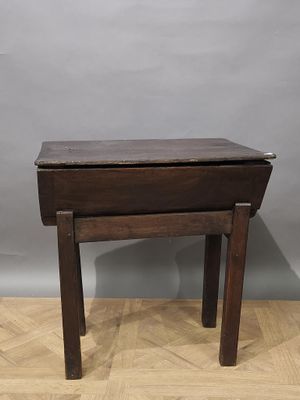 an old wooden table with a drawer on top of it on a wooden floor