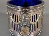 an antique silver and blue glass candle holder on a table