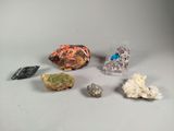 several different types of rocks and crystals on a white surface