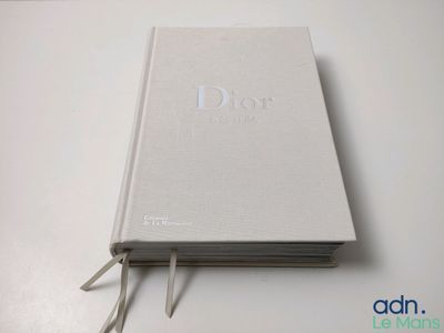 a white book sitting on top of a white table