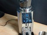 a blender sitting on a table with a cup next to it
