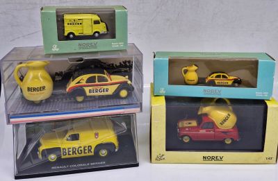 three boxed toy cars in boxes on a white surface