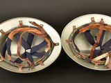 pair of silver and copper plated speakers on black background