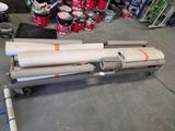 two rolls of paper sitting on a cart in a garage